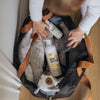 baby bag holding blankets, toys, Pumpd silicone breast pump and the New Edition NZ family sanitising pack, including adult hand sanitiser and baby hand sanitiser spray